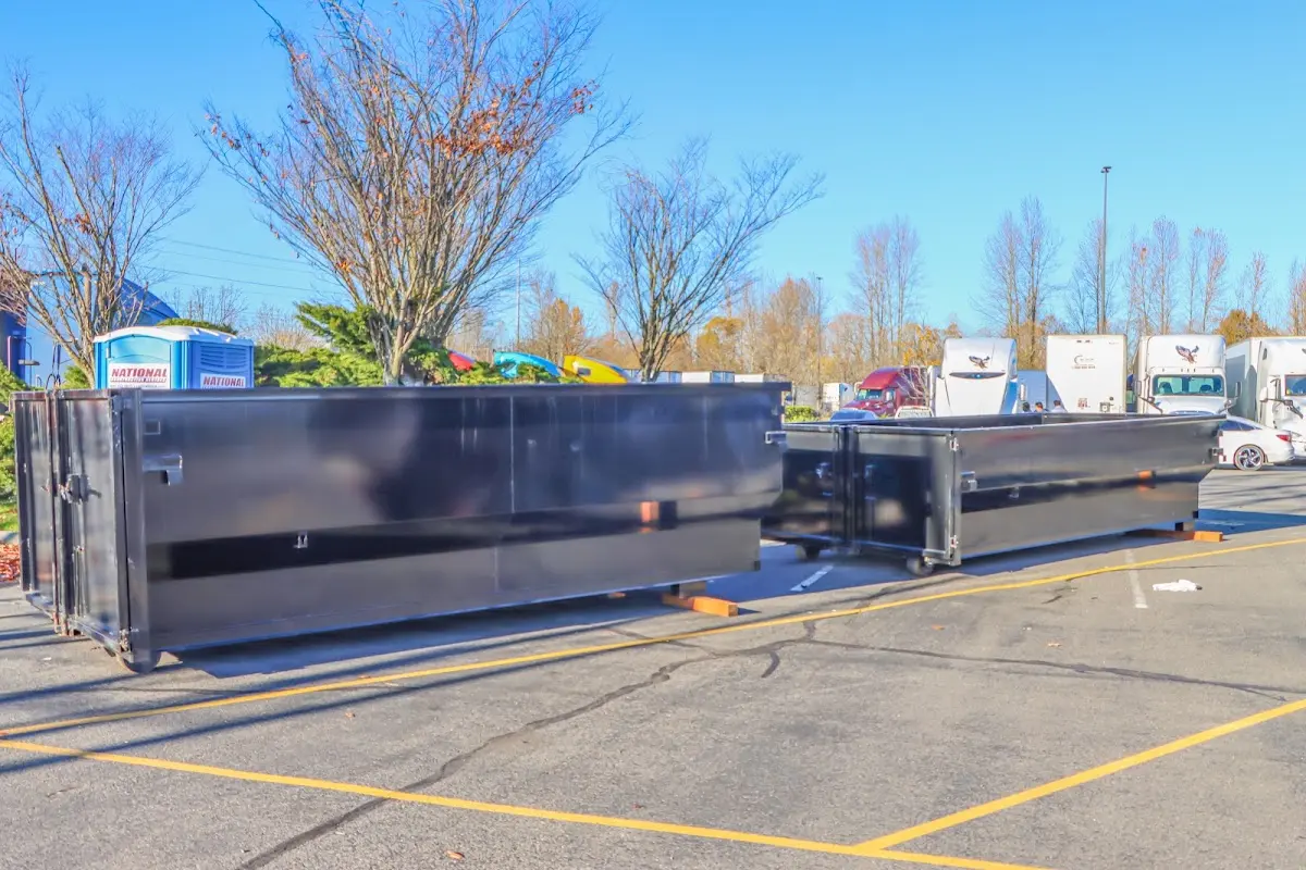 Professional dumpster rental service with roll-off container on residential driveway in Ellisville